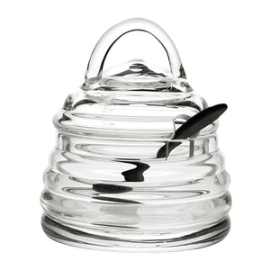 The William Yeoward Crystal Honeybee Honey Jar and Spoon features a beehive-inspired clear glass jar with matching lid and black spoon. Proposition 65 warning applies.