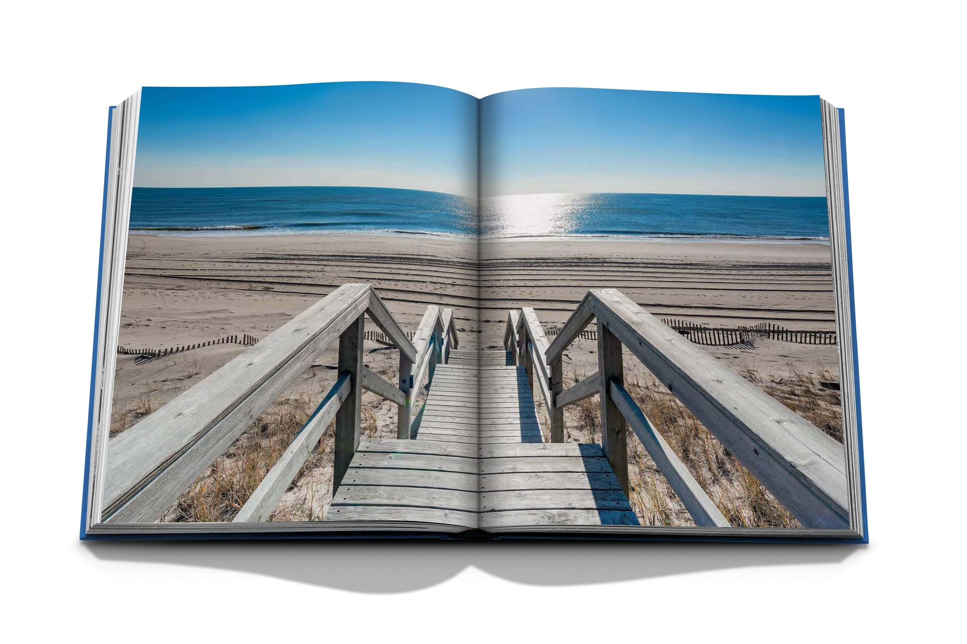 An open book with stairs leading to the beach, perfect for leisure activities in the Hamptons Private by Assouline.