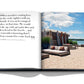 An open book of Hamptons Private with an image of a beach and chairs, perfect for leisure by Assouline.
