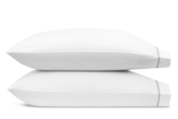Two white pillows from the Matouk Hatch Bedding Collection in Oak stacked horizontally, featuring edge stitching on the bottom pillow, crafted from Ceylon percale and OEKO-TEX® Standard 100 certified for premium comfort.