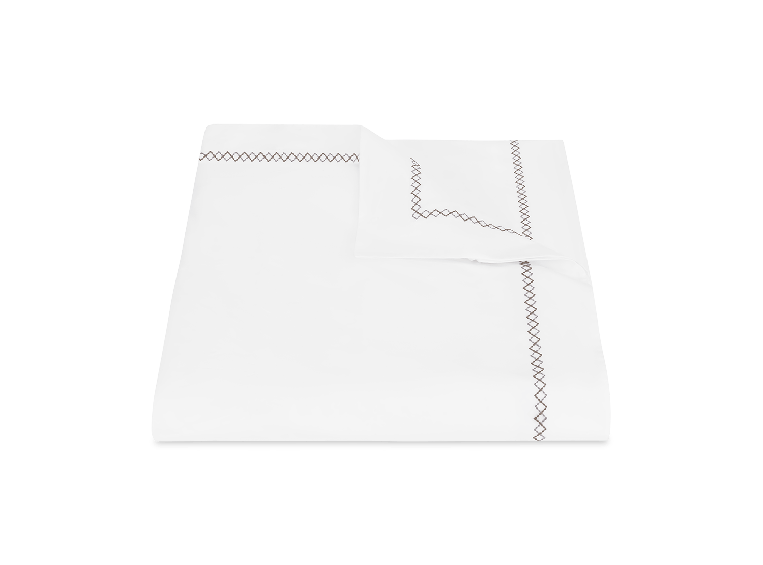 The Matouk Hatch Bedding Collection in Oak features a neatly folded white percale sheet set with a matching pillowcase, both accented by a simple black zigzag border and crafted from 520-thread-count OEKO-TEX® Standard 100 certified fabric.