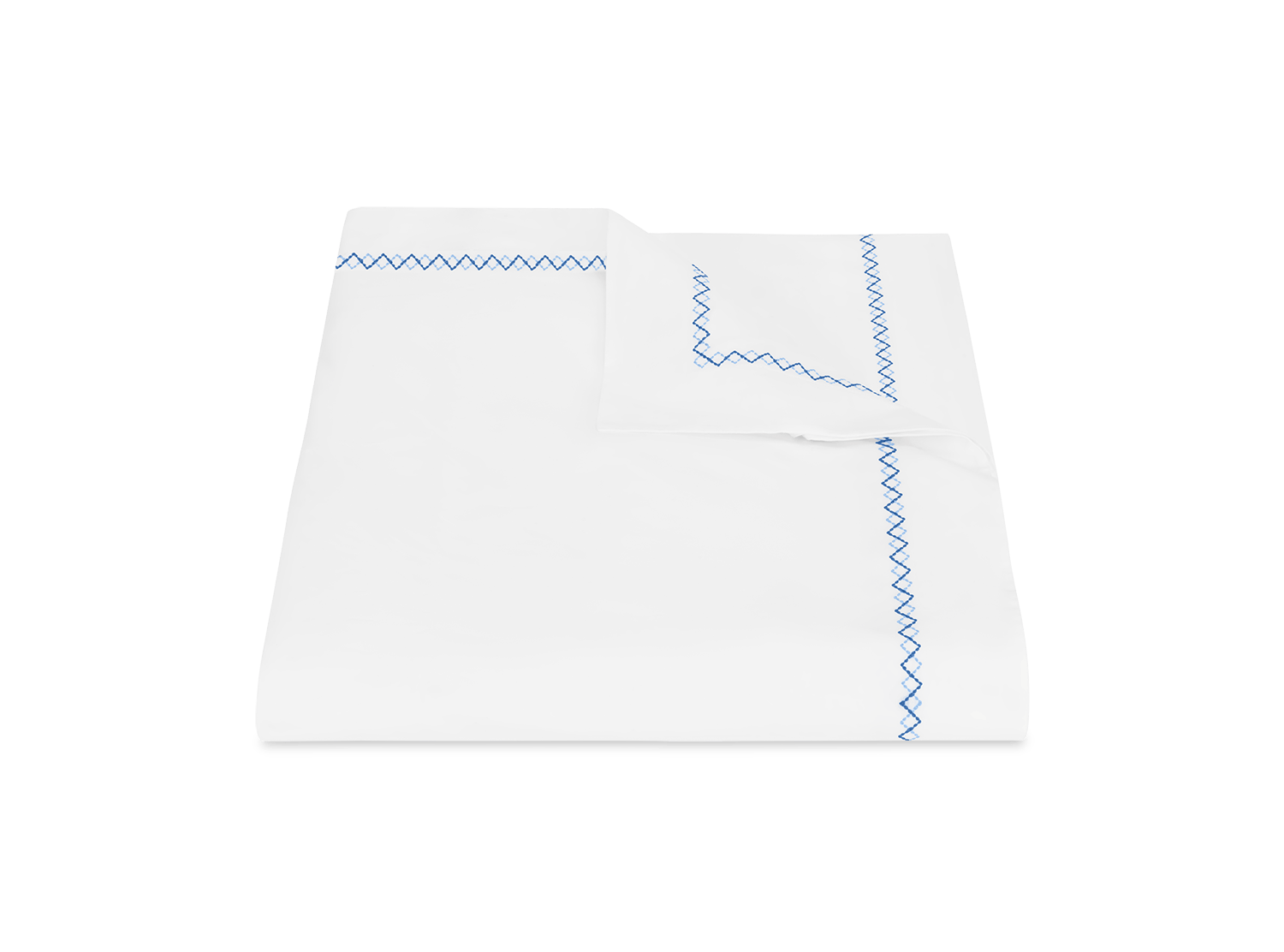 The Matouk Hatch Bedding Collection, Sky, features a white bedsheet and pillowcase set with blue zigzag and French knot stitching on the edges, crafted from luxurious 520 thread count Ceylon percale and displayed on a plain background.