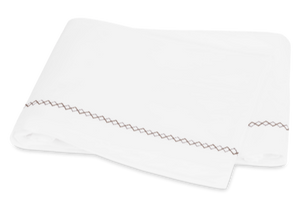 White folded towel with French knot decorative stitching from Matouk Hatch Bedding Collection, Oak.