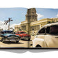 A book opened to a page showing a vintage photograph of classic cars driving in front of an ornate building with palm trees, resembling a historic cityscape during Havana's cultural renaissance, from the Assouline collection titled "Havana Blues.