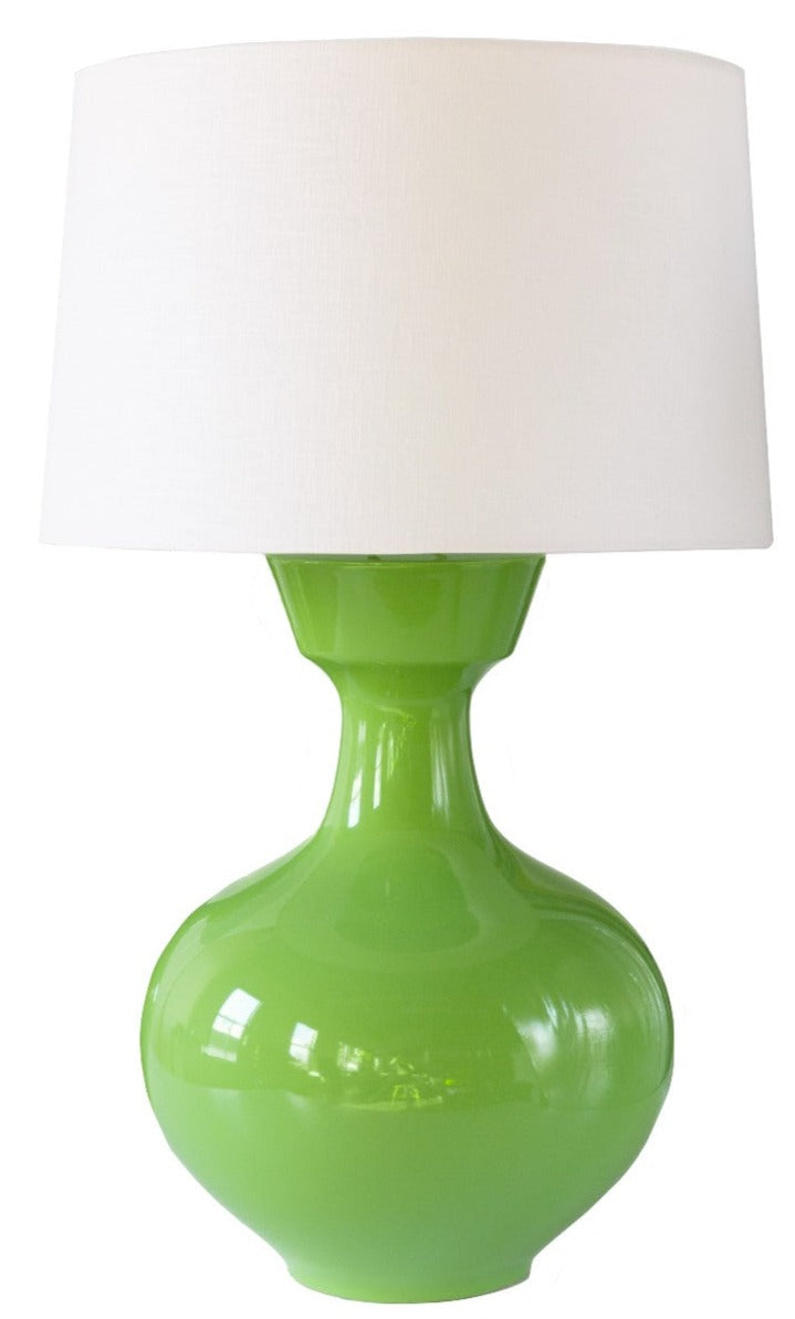 The Han Table Lamp by Hwang Bishop features a wide, rounded base in Hive Green ceramic and is topped with a crisp white fabric lampshade, shown against a plain background.