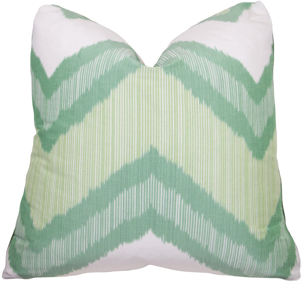 The Chevron Green Ikat Pillow by Associated Design is a handmade square cushion featuring a white and green zigzag pattern, double-sided and measuring 22" x 22".