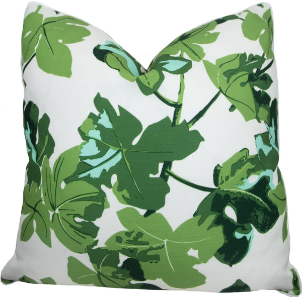 A square handmade pillow with a white background features a bold green leaf pattern, perfect for adding a touch of nature to any room. This is the Fig Leaf On White Outdoor Pillow from Associated Design.