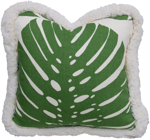 A green and white Exoticus Elephant Leaf Pillow by Associated Design, with a tropical leaf pattern, edged with a soft, fluffy border.