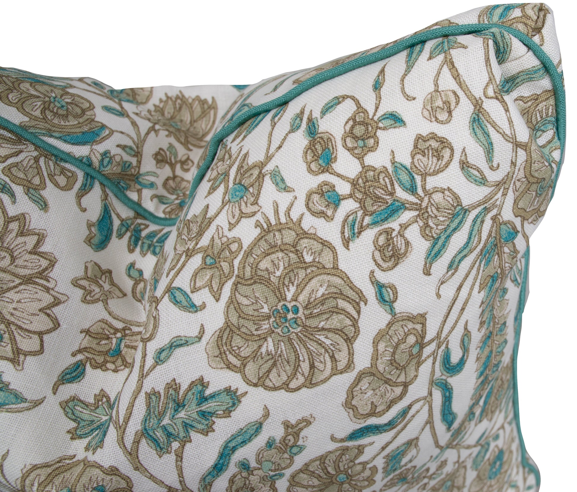 Close-up of the Cormnandal Teal Pillow by Hive Custom Pillows, featuring a white base with beige and teal floral patterns and a teal piped edge.