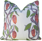 The Hive Custom Pillows' Cacao Shale Rose Pillow features cocoa pods with green leaves on a white background. This double-sided, handmade piece is crafted in the USA and filled with luxurious down for ultimate comfort.