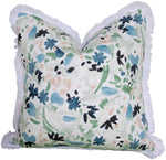 The Wildflower Navy Leaf Pillow by Hive Custom Pillows is a 22" x 22" handmade, USA-crafted decorative pillow featuring a floral pattern in shades of blue, green, black, and peach with white fringe.