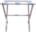 A Sorella Glenn White Luggage Rack in Fern River Blue, folded and standing against a white background on a maple hardwood floor.