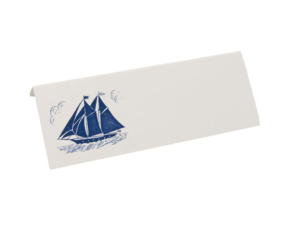 The Printery Navy Schooner Place Card by Printery is elegantly folded bone white, with a serene navy schooner illustration on the left.