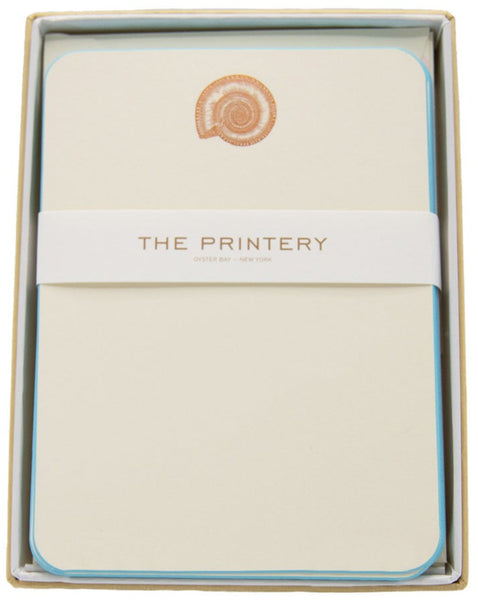 A boxed set of elegant stationery by Printery, featuring a subtle nautilus imprint in the top center, encased in a light blue box.