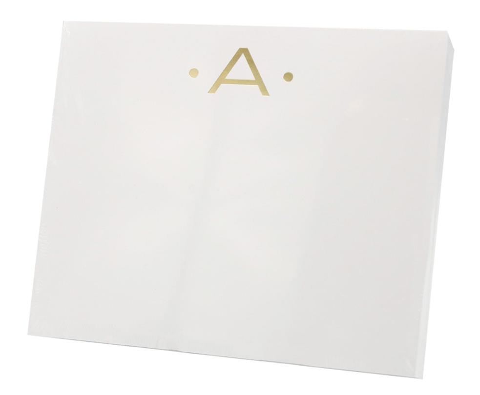 The Gold Initial Large Notepad by Black Ink features a white rectangular box with a gold letter "A" and two gold dots on the front, crafted from high-quality heavy weight paper.