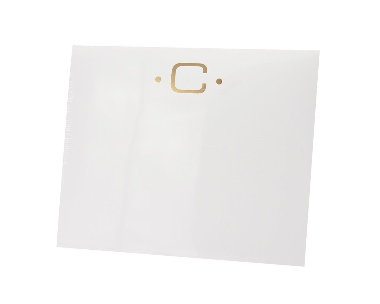 The Black Ink Gold Initial Large Notepad is a white square notepad made from heavyweight paper, featuring a gold letter "C" at the top center with two small gold dots on either side.
