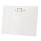 The Gold Initial Large Notepad by Black Ink features a white square card made from heavyweight paper, with a gold letter "B" centered between two small gold dots near the top.