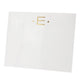 The Black Ink Gold Initial Large Notepad features a white square design made from heavyweight paper, with a gold letter “E” between two gold dots, shown on a white background.