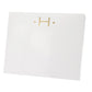 The Gold Initial Large Notepad by Black Ink comes in a white square box made of heavy weight paper, featuring a minimalist gold letter "H" and two gold dots on the front against a plain white background.