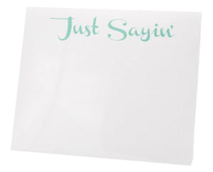 The Black Ink Just Sayin' Large Notepad features "Just Sayin'" in light green cursive atop quality white paper—ideal for jotting notes or displaying in a Lucite Notepad Holder.