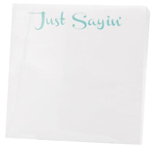 The Black Ink Just Sayin' Small Paddie features "Just Sayin’" in light blue-green atop a white, high-quality paper napkin—ideal for display in a Lucite Notepad Holder.