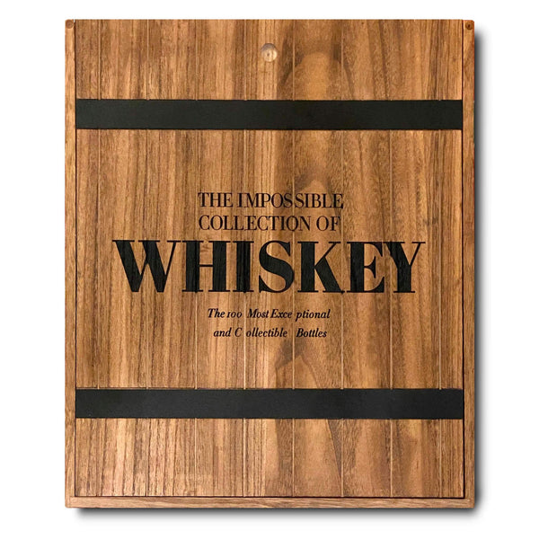 The Assouline wooden box features "The Impossible Collection of Whiskey: The 100 Most Exceptional and Collectible Bottles" in black capitals, highlighting a curated journey through prestigious distilleries and rare bourbon treasures.