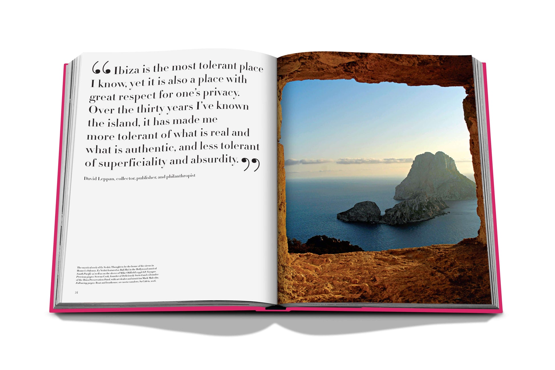 Open book on a desk showing a quote about Ibiza Bohemia and a full-page photograph of Balearic cliffs in the sea at sunset by Assouline.