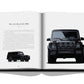 An open book displaying "Iconic: Art, Design, Advertising, and the Automobile" by Assouline. The left page contains a description and a side-view image of the vehicle, while the right page features a front-view image, highlighting this supercar among automotive celebrities.