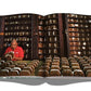 An open book shows a man meticulously arranging exceptional cigars from renowned makers in a room filled with Assouline's "The Impossible Collection of Cigars" on its shelves.