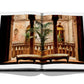 An open book displaying an ornate indoor setting with carved wooden pillars, intricate wall designs, and two cushioned benches facing a potted plant, capturing the timeless Italian style reminiscent of hidden side streets: "Italian Chic" by Assouline.