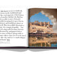 Open book showing a page with text about Jaipur, the Pink City, and a photo of an ancient architectural site viewed through an ornate stone window from the "Jaipur Splendor" by Assouline.
