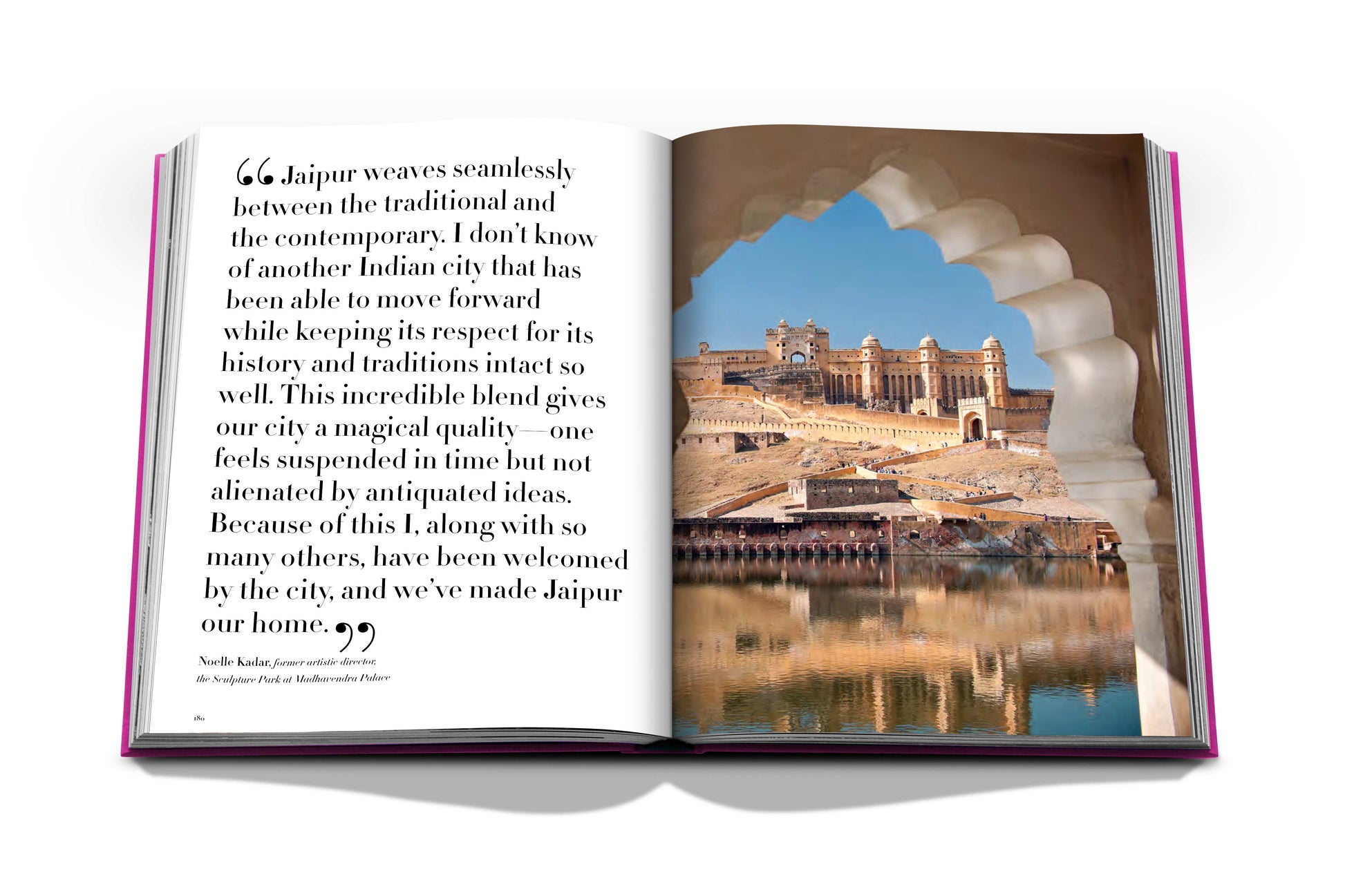 Open book showing a page with text about Jaipur, the Pink City, and a photo of an ancient architectural site viewed through an ornate stone window from the "Jaipur Splendor" by Assouline.