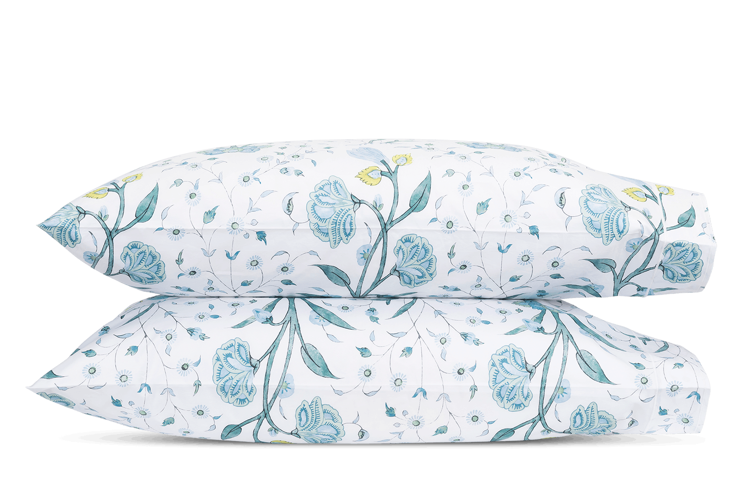Two white pillows from the Schumacher Khilana Bedding Collection by Matouk, featuring a blue and yellow hand-block floral pattern, are stacked against a plain background.