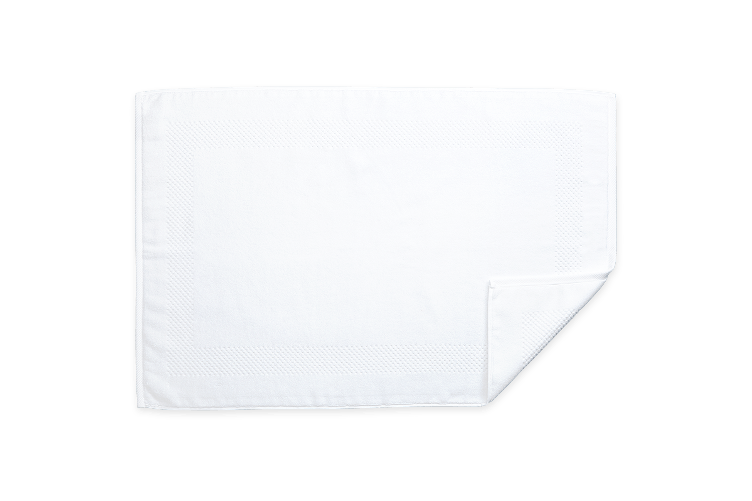 The Matouk Lotus Bath Collection in White features a neatly folded bath mat, crafted from low-twist cotton for extra softness, with a textured border design. Made by Matouk in Portugal, it rests elegantly on a plain background.