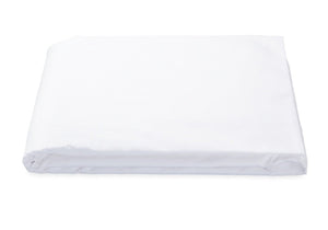 A Matouk Luca 17" Fitted Sheet in white, made from Egyptian cotton percale with a 500 thread count, is neatly folded on a plain background. This bedding essential is OEKO-TEX® Standard 100 certified for quality and safety.