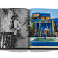 An open book displaying black and white and color photographs, one featuring a person leaning on a railing and the other showcasing a vibrant blue building with a fountain, emblematic of Marrakech culture from Assouline's Marrakech Flair.