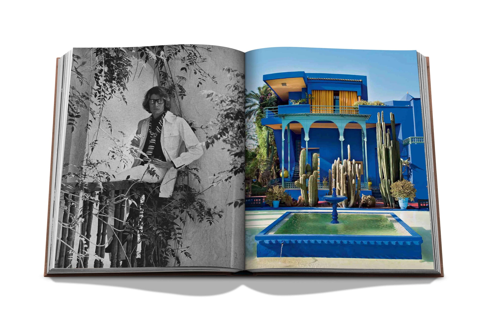An open book displaying black and white and color photographs, one featuring a person leaning on a railing and the other showcasing a vibrant blue building with a fountain, emblematic of Marrakech culture from Assouline's Marrakech Flair.