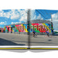 A Miami Beach book with a picture of a colorful mural on the cover capturing the essence of Miami life by Assouline.