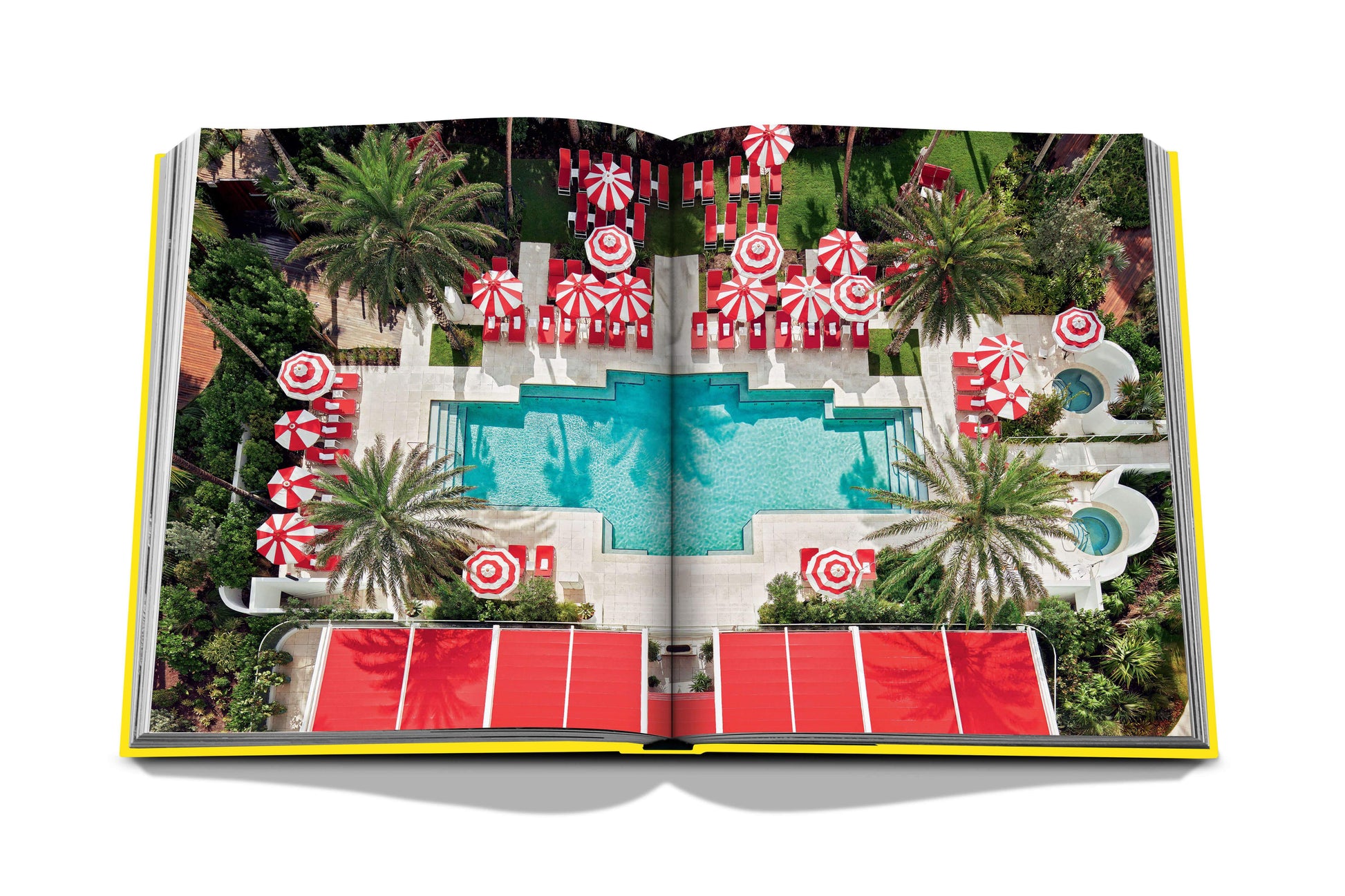 An open book with a pool and red umbrellas, perfect for Assouline Miami Beach life.