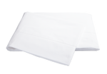 A pair of neatly folded white Matouk Milano Bedding Collection pillowcases isolated on a black background.