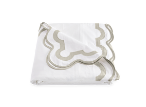A folded white bed sheet from the Matouk Mirasol Bedding Collection in Silver, crafted from Egyptian cotton percale with a gray and white scalloped border design.