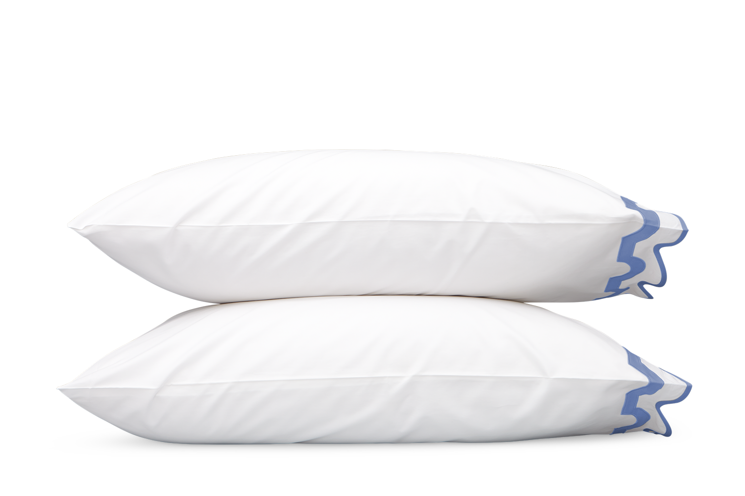 Two white pillows from the Matouk Mirasol Bedding Collection in Azure, featuring blue trim and crafted from luxurious 600 thread count Egyptian cotton percale, are stacked against a plain gray background.