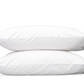 Two white pillows from the Matouk Mirasol Bedding Collection in Silver, crafted from Egyptian cotton percale with a 600 thread count, are stacked on top of each other against a plain gray background.