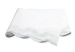 The Mirasol Bedding Collection, Opal by Matouk features a folded white sheet with a scalloped edge and light green border, crafted from 600 thread count Egyptian cotton percale, shown on a plain background.