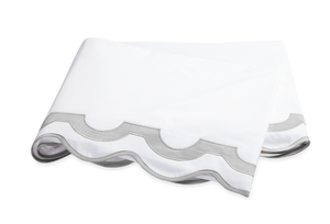 The Mirasol Bedding Collection in Silver by Matouk features a folded white bedsheet with a gray scalloped border, crafted from Egyptian cotton percale with a 600 thread count, displayed on a white background.