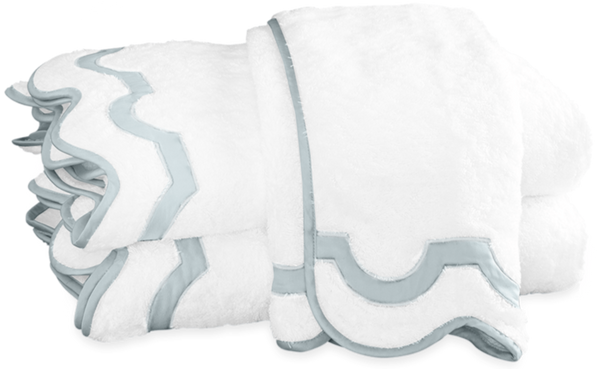 Two neatly folded white towels from the Matouk Mirasol Bath Collection - Pool, with decorative light blue borders, placed on top of each other.