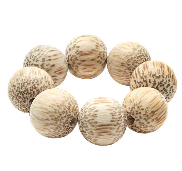 The Deborah Rhodes Cocoa Wood Bracelet Napkin Ring Set features eight round, light brown wood beads with dark speckled patterns—an elegant and unique addition to any stylish place setting.