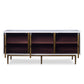 The Naples Cabinet by Mr Brown is a mid-century modern sideboard with three open wooden compartments and aged brass doors on slender legs. It features an empty interior, sleek dimensions, and a white smooth gesso finish that adds elegance.