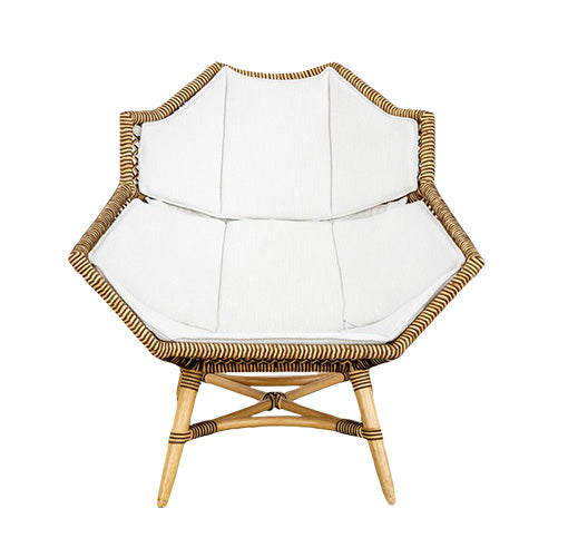 The McGuire Furniture Nozomu Lounge Chair, with its artistic vision and hand-woven rattan design, features a sleek white cushion for added comfort.