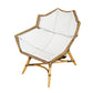 The McGuire Furniture Nozomu Lounge Chair is a hand-woven rattan chair designed with an artistic vision, featuring a white cushion.